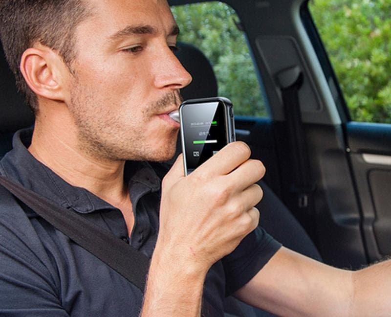 Driver using a portable alcohol tester
