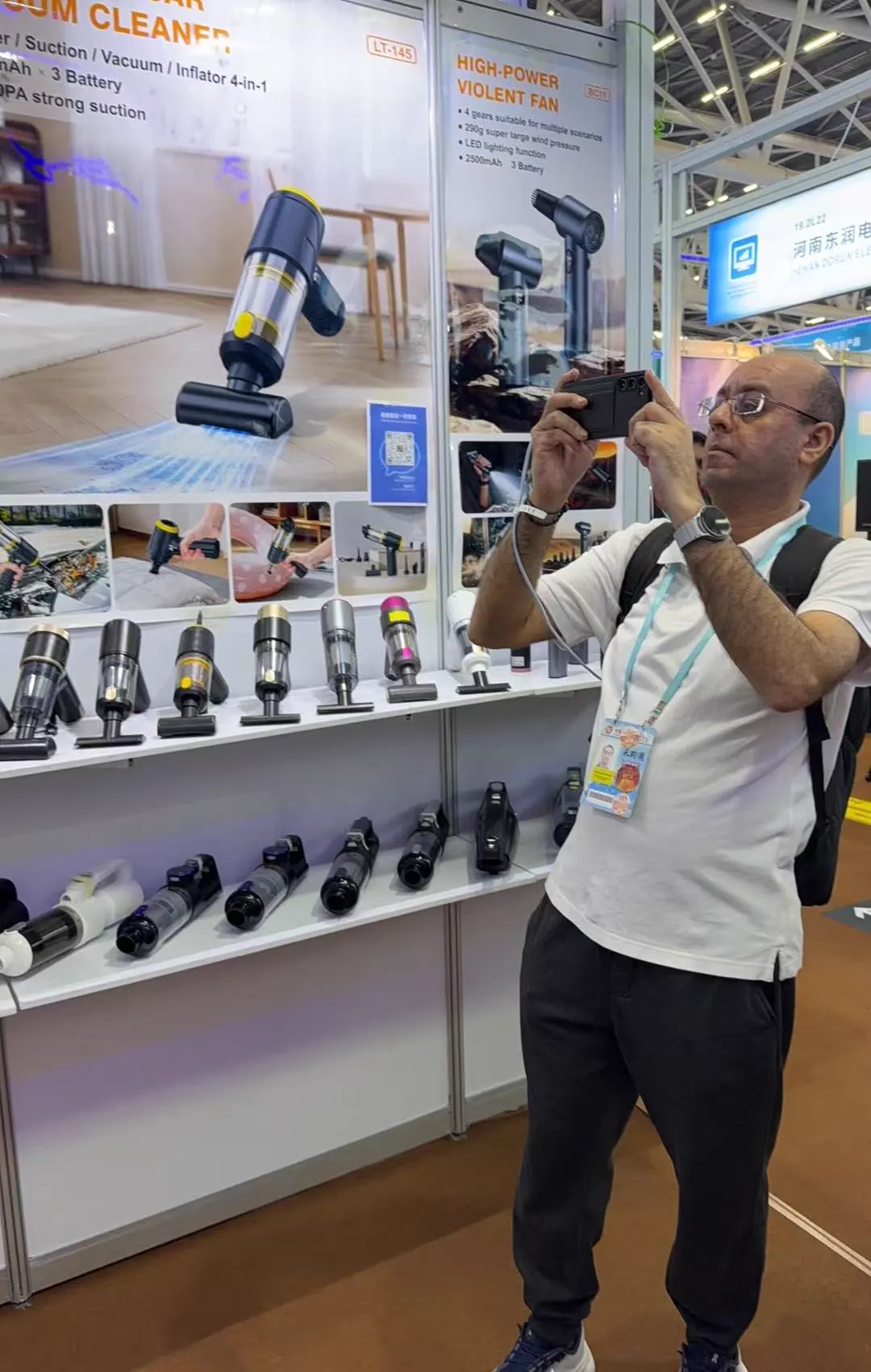 Buyer photographing products at the DRC trade show booth