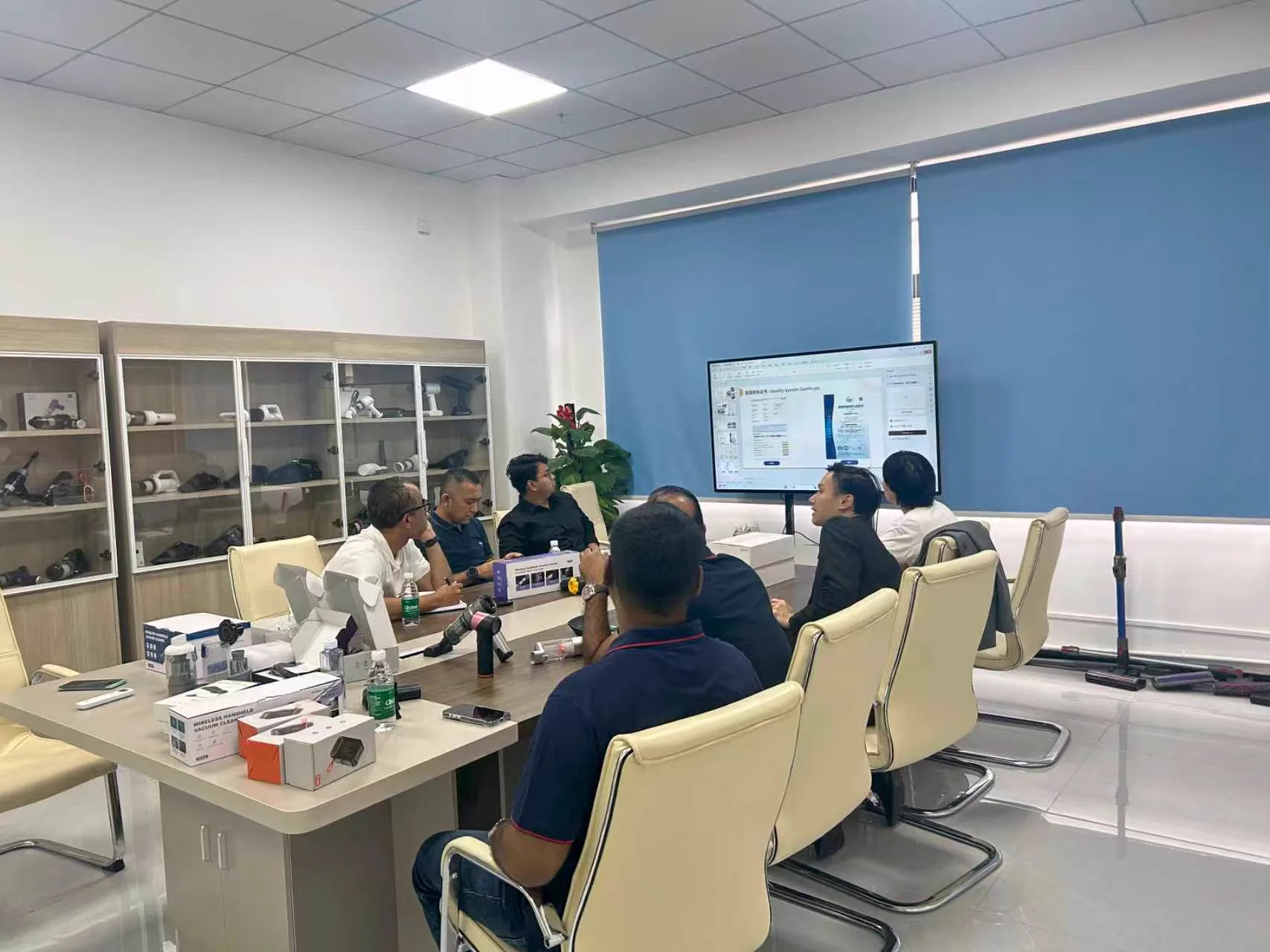 Customers reviewing vacuum cleaner products in a DRC meeting