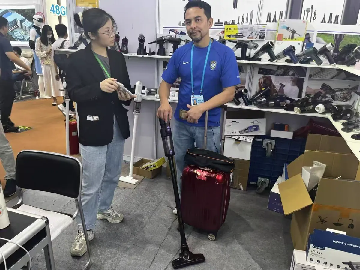 Customer viewing a cordless vacuum demonstration at the DRC booth